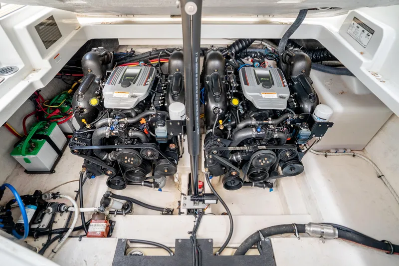 Slide: The Image of 2015 Crownline 294 CR engine compartment with dual engines and battery setup. - 23