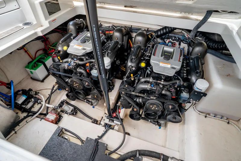 Slide: The Image of Engine compartment of 2015 Crownline 294 CR boat, featuring dual inboard motors. - 24