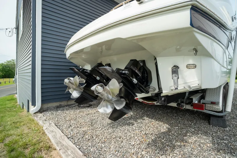 Slide: The Image of Rear view of 2015 Crownline 294 CR boat with dual propellers on gravel. - 8