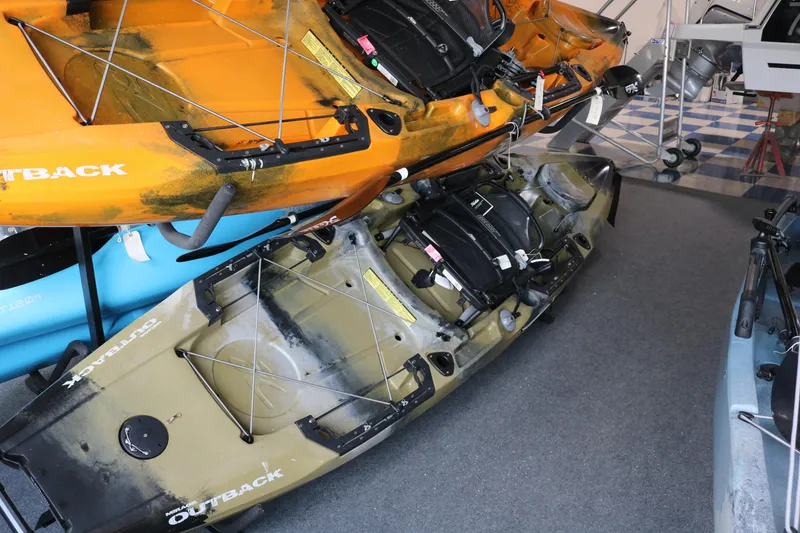 Slide: The Image of 2023 Hobie Mirage Outback kayaks displayed in a showroom, showcasing vibrant colors and design. - 1