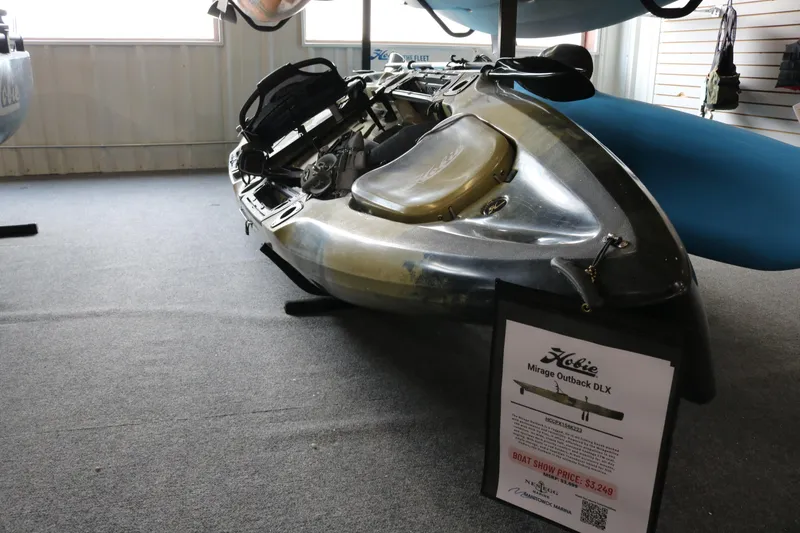 Slide: The Image of 2023 Hobie Mirage Outback kayak displayed indoors with price sign. - 3