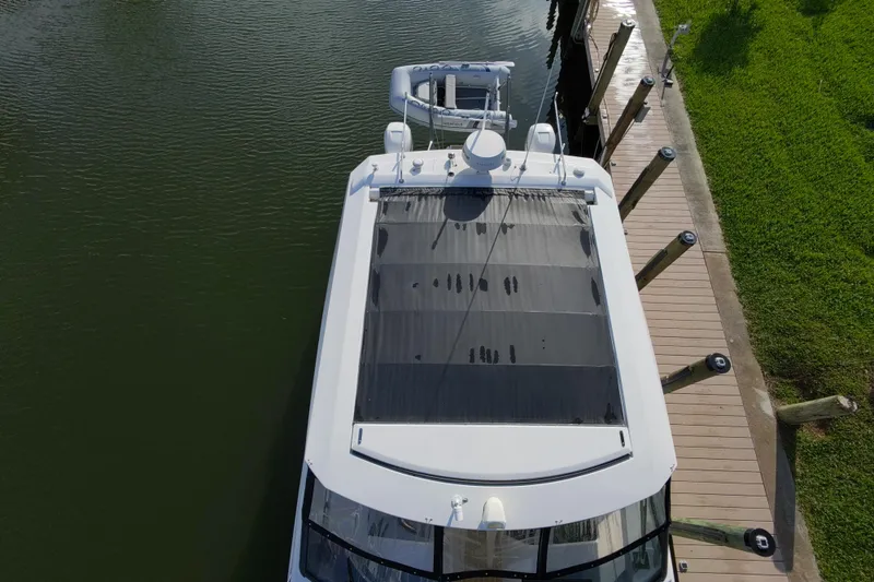 Slide: The Image of Aerial view of 2019 Aquila 36 Sport yacht docked by a wooden pier. - 10