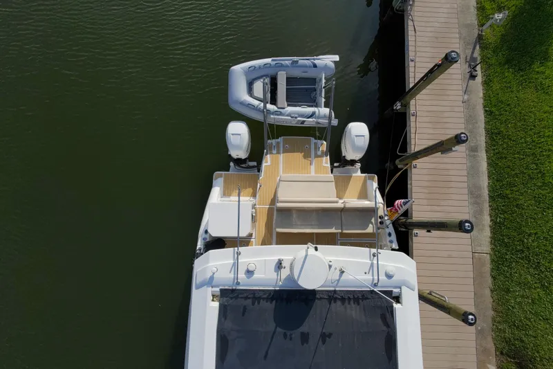 Slide: The Image of Aerial view of 2019 Aquila 36 Sport yacht docked, featuring dual engines and inflatable boat. - 11