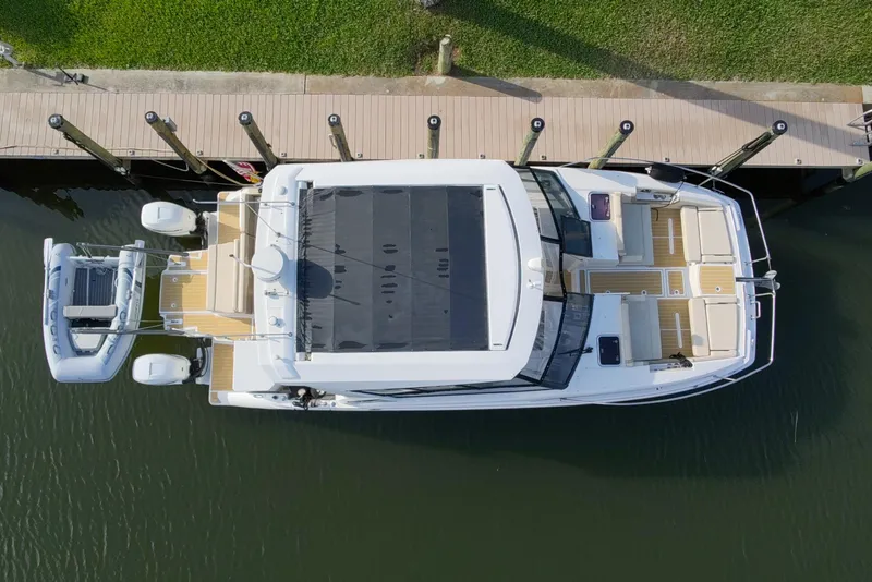 Slide: The Image of Overhead view of 2019 Aquila 36 Sport yacht docked by a wooden pier. - 12