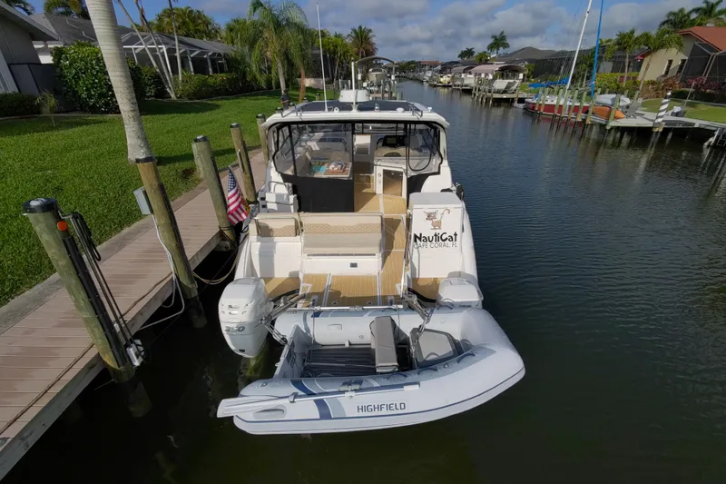 Slide: The Image of Aquila 36 Sport 2019 docked in a scenic canal with lush greenery. - 13