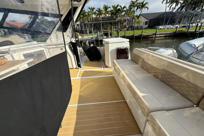 Slide: The Image of Aquila 36 Sport 2019 yacht interior with beige seating and wooden flooring. - 17