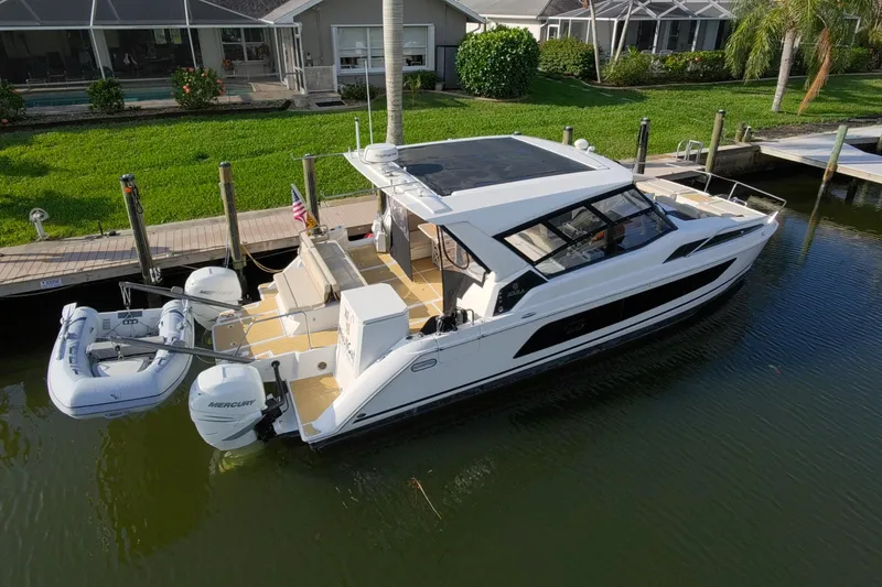 Slide: The Image of Aquila 36 Sport 2019 boat docked, featuring sleek design and spacious deck. - 2