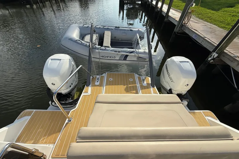 Slide: The Image of Aquila 36 Sport 2019 with twin Mercury engines and inflatable boat at dock. - 20