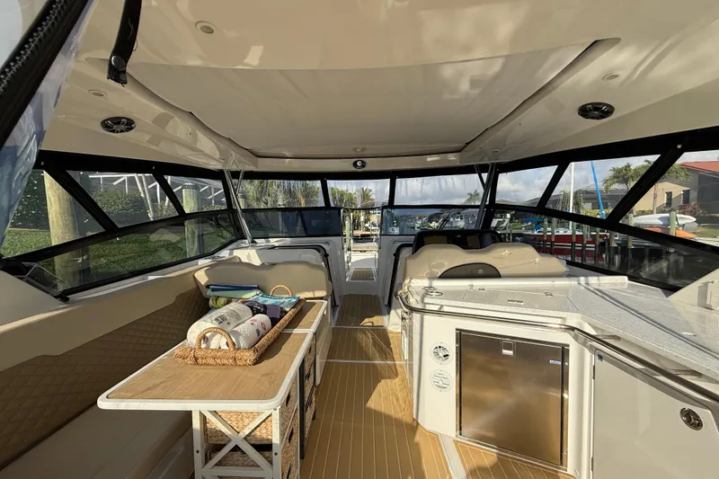Slide: The Image of Interior view of 2019 Aquila 36 Sport boat with seating and table setup. - 22
