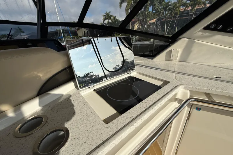 Slide: The Image of Interior of 2019 Aquila 36 Sport yacht featuring a sleek kitchen area with cooktop. - 26