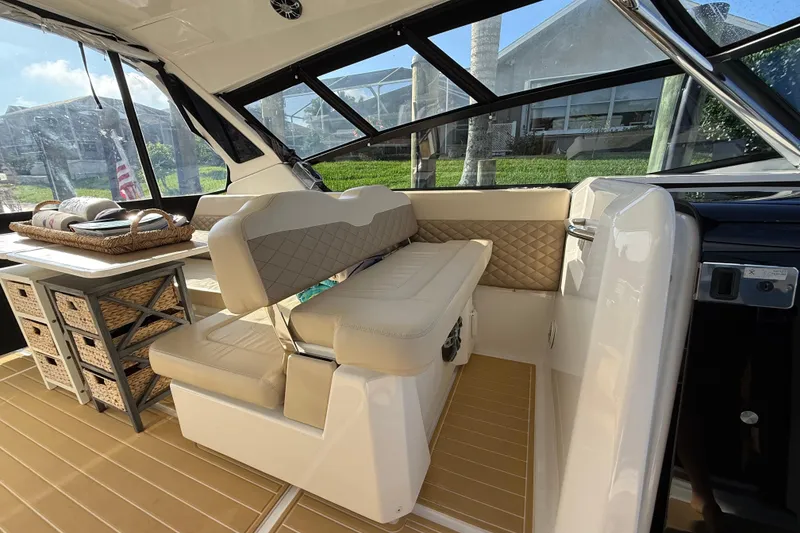 Slide: The Image of Interior of 2019 Aquila 36 Sport boat with beige seating and wicker storage baskets. - 27