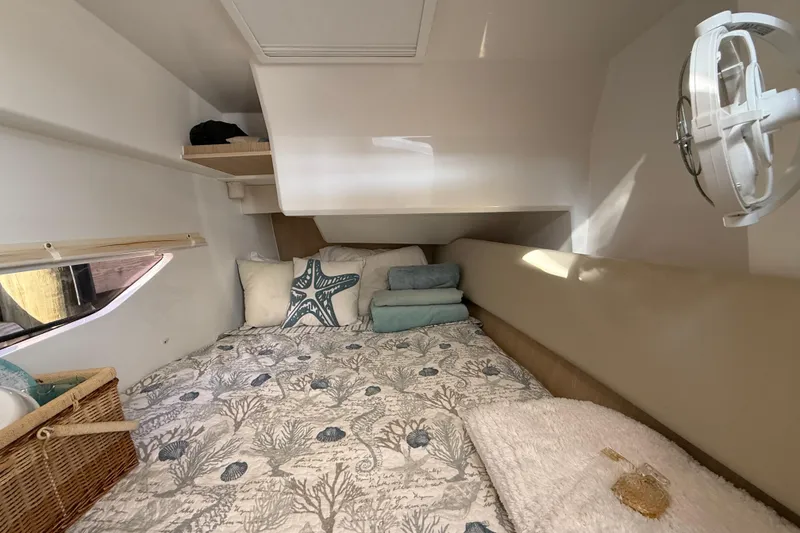 Slide: The Image of Cozy cabin interior of 2019 Aquila 36 Sport with nautical-themed bedding and decor. - 33