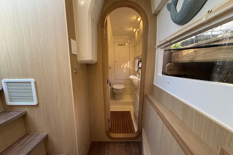 Slide: The Image of Interior of 2019 Aquila 36 Sport yacht, featuring a compact bathroom with wooden accents. - 34