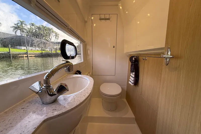 Slide: The Image of Luxurious bathroom interior of 2019 Aquila 36 Sport yacht with modern fixtures and scenic window view. - 35