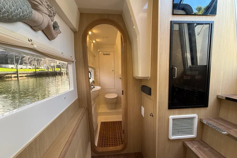 Slide: The Image of Interior of 2019 Aquila 36 Sport yacht, featuring a modern bathroom and wooden accents. - 36