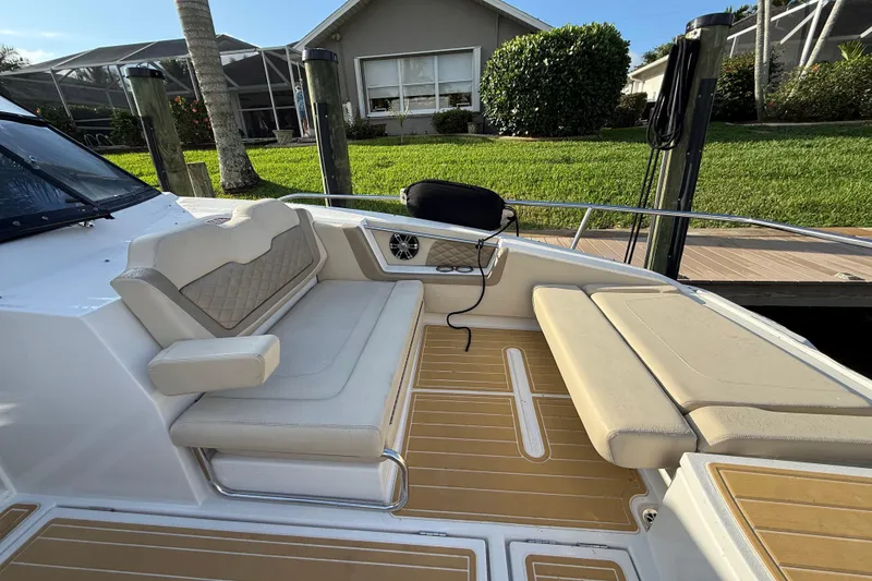 Slide: The Image of Aquila 36 Sport 2019 boat interior with beige seating and wooden deck. - 40