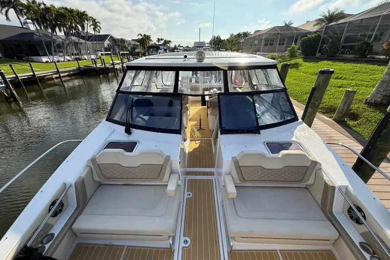 Slide: The Image of 2019 Aquila 36 Sport boat docked, featuring spacious seating and sleek design. - 42