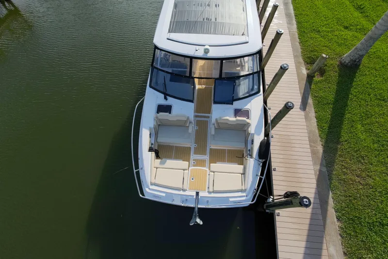Slide: The Image of Aerial view of 2019 Aquila 36 Sport boat docked by a wooden pier. - 9