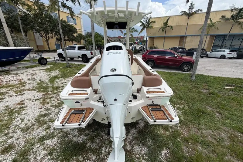 Slide: The Image of 2023 Pioneer 202 Islander boat with powerful outboard motor, parked outdoors. - 3