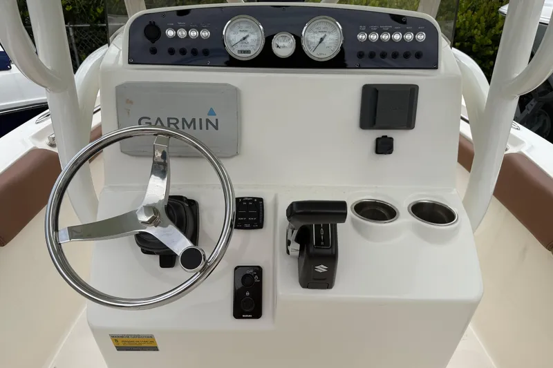 Slide: The Image of 2023 Pioneer 202 Islander boat dashboard with Garmin navigation and Suzuki controls. - 7