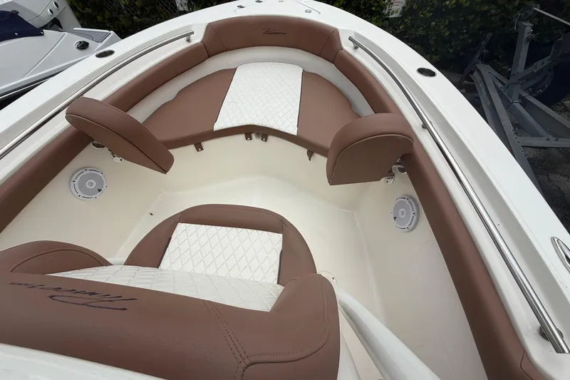 Slide: The Image of 2023 Pioneer 202 Islander boat interior with brown and white cushioned seating. - 8
