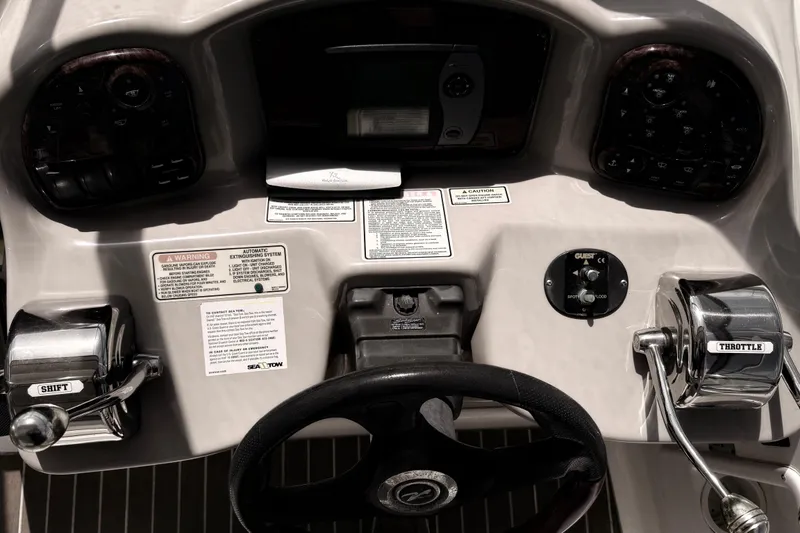 Slide: The Image of Control panel of a 2004 Sea Ray 340 Sundancer boat with steering wheel and throttle. - 10