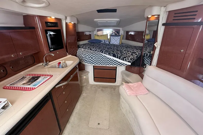 Slide: The Image of Interior of a 2004 Sea Ray 340 Sundancer yacht with kitchen and sleeping area. - 11