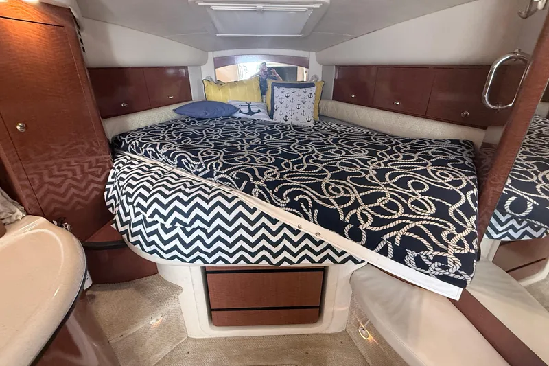 Slide: The Image of Luxurious cabin interior of 2004 Sea Ray 340 Sundancer with nautical-themed bedding. - 13