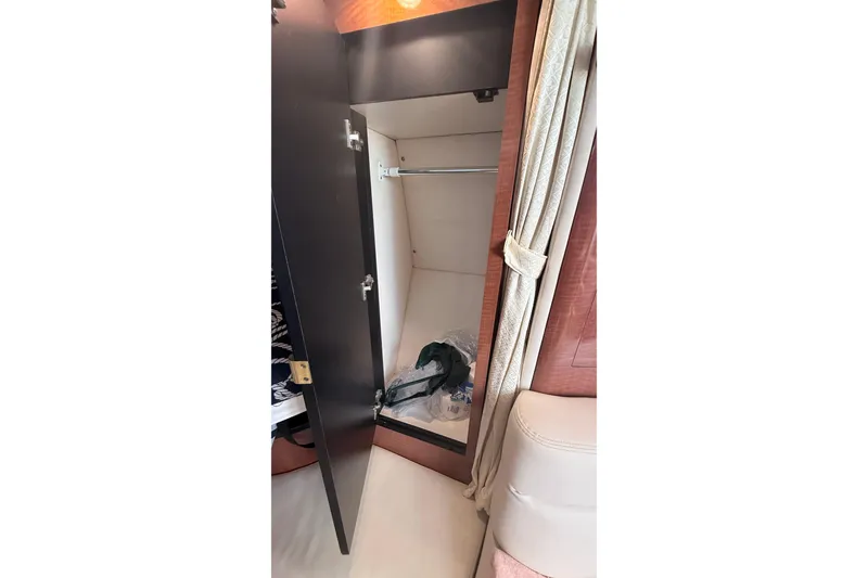 Slide: The Image of Interior closet of 2004 Sea Ray 340 Sundancer yacht with open door and hanging space. - 17