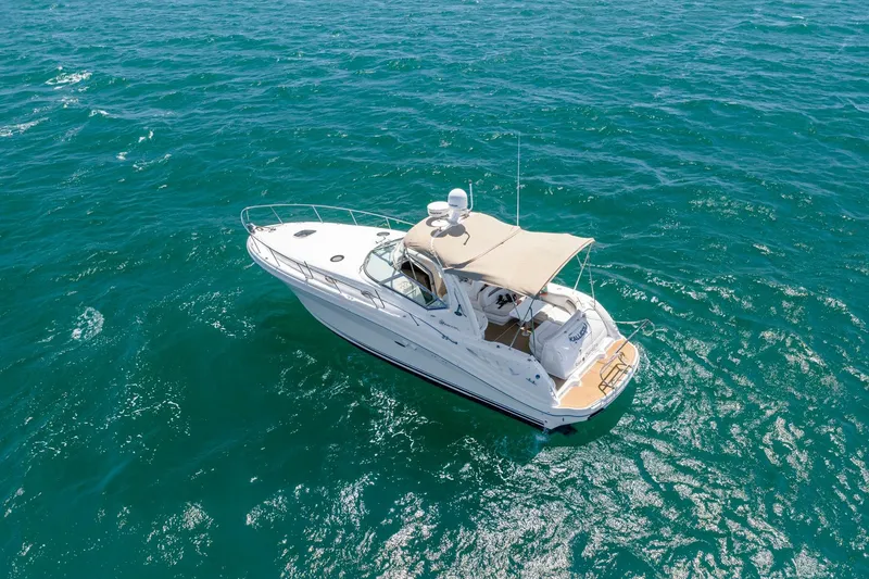 Slide: The Image of 2004 Sea Ray 340 Sundancer cruising on clear blue ocean waters. - 40