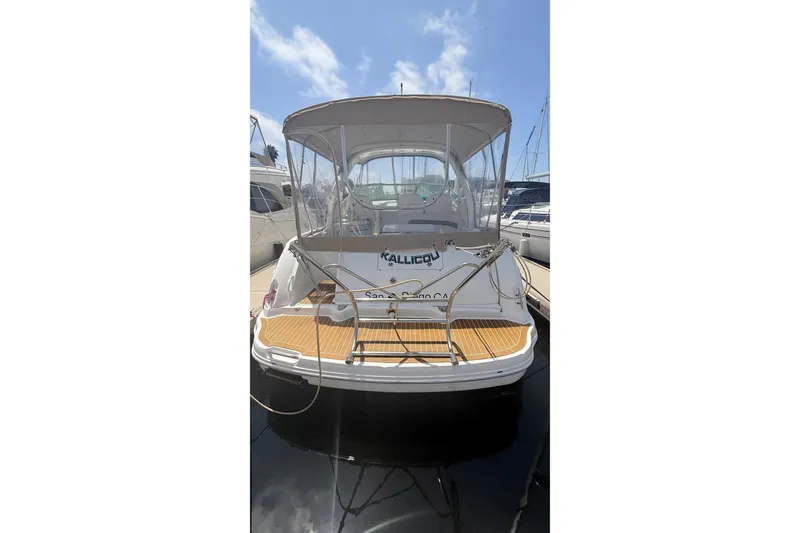 Slide: The Image of 2004 Sea Ray 340 Sundancer yacht docked, rear view with canopy and wooden deck. - 6