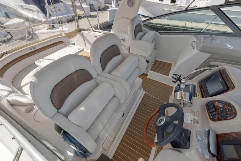 Slide: The Image of 2004 Sea Ray 340 Sundancer cockpit with plush seating and modern controls. - 21