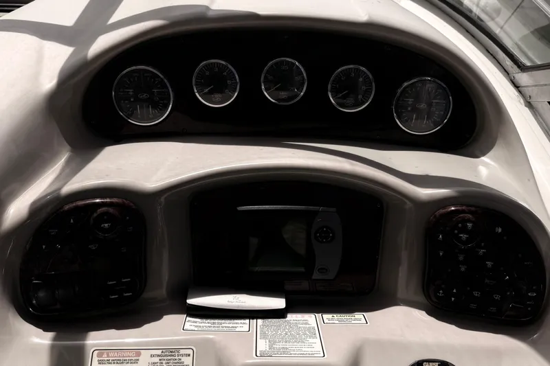 Slide: The Image of Dashboard of a 2004 Sea Ray 340 Sundancer boat with gauges and controls. - 8