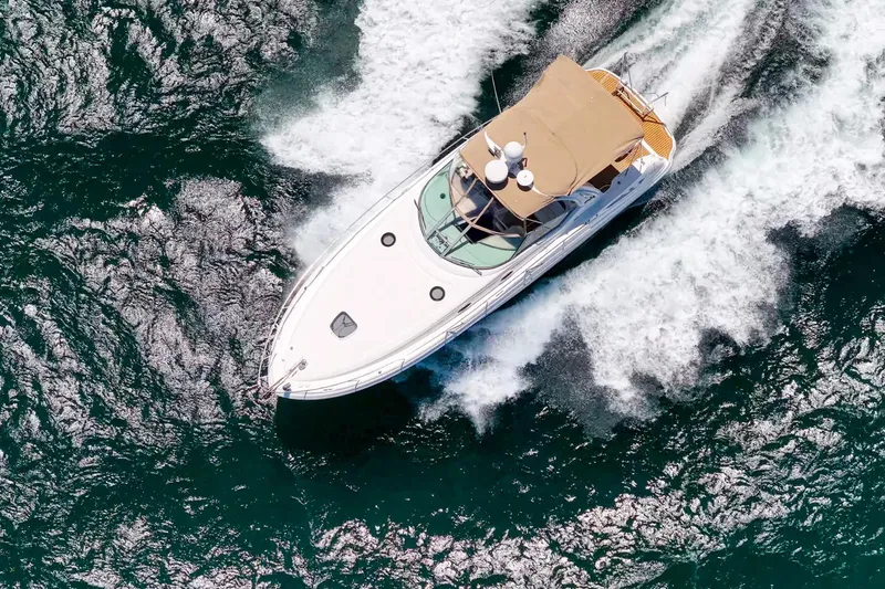 Slide: The Image of Aerial view of 2004 Sea Ray 340 Sundancer cruising on open water. - 56