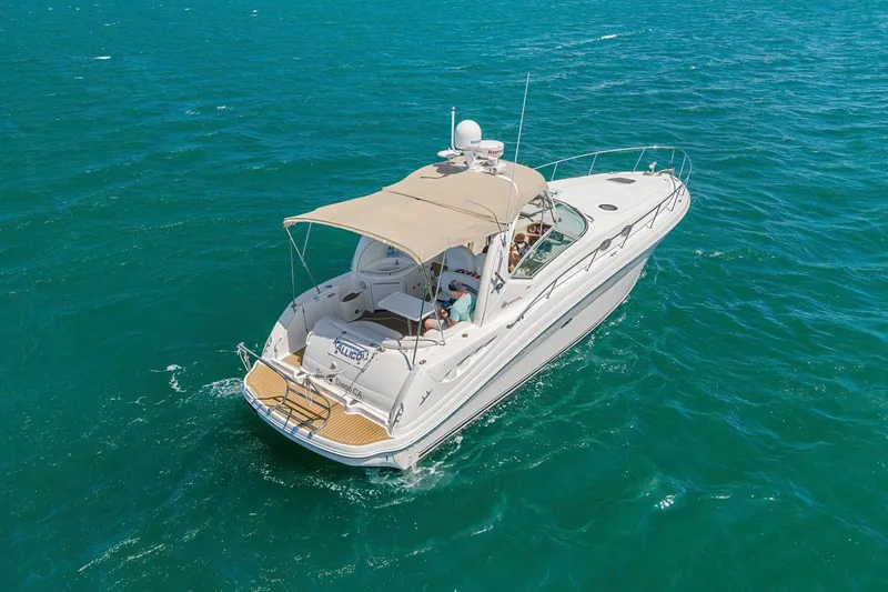 Slide: The Image of 2004 Sea Ray 340 Sundancer cruising on open blue waters. - 36