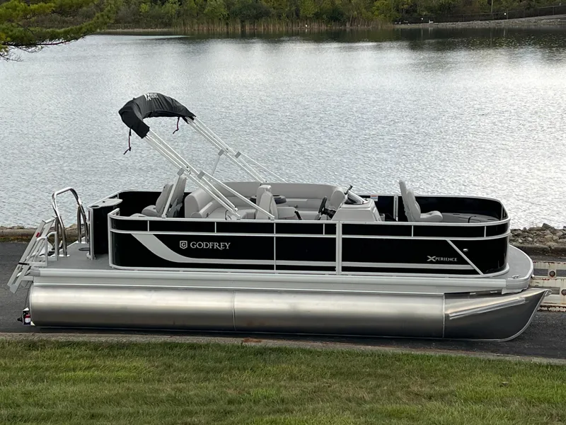 The Image of 2025 Godfrey Xperience 2086 FX pontoon boat by a serene lake. - 1