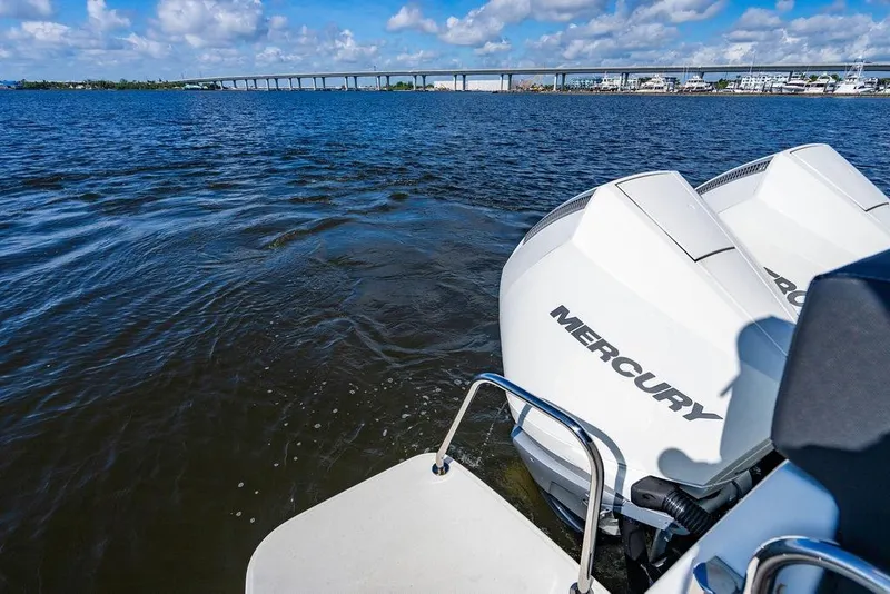 Slide: The Image of 2023 Jeanneau NC 1095 with Mercury engines on a scenic waterway. - 27
