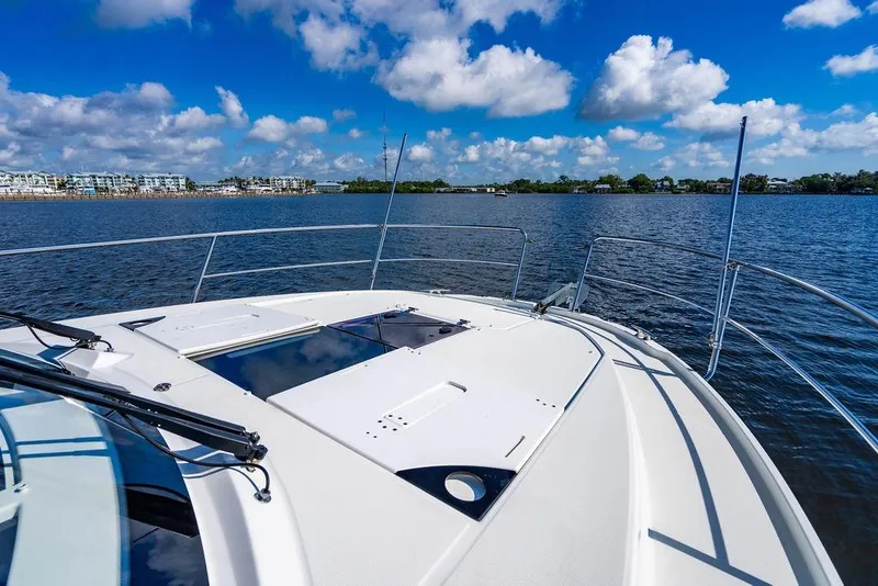 Slide: The Image of 2023 Jeanneau NC 1095 boat deck with scenic waterfront view under blue sky. - 32