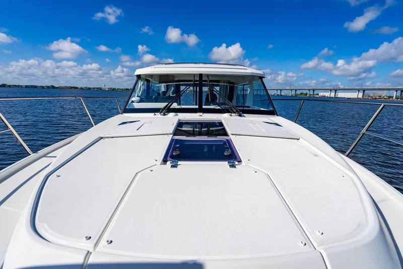 Slide: The Image of 2023 Jeanneau NC 1095 boat on water under blue sky. - 34