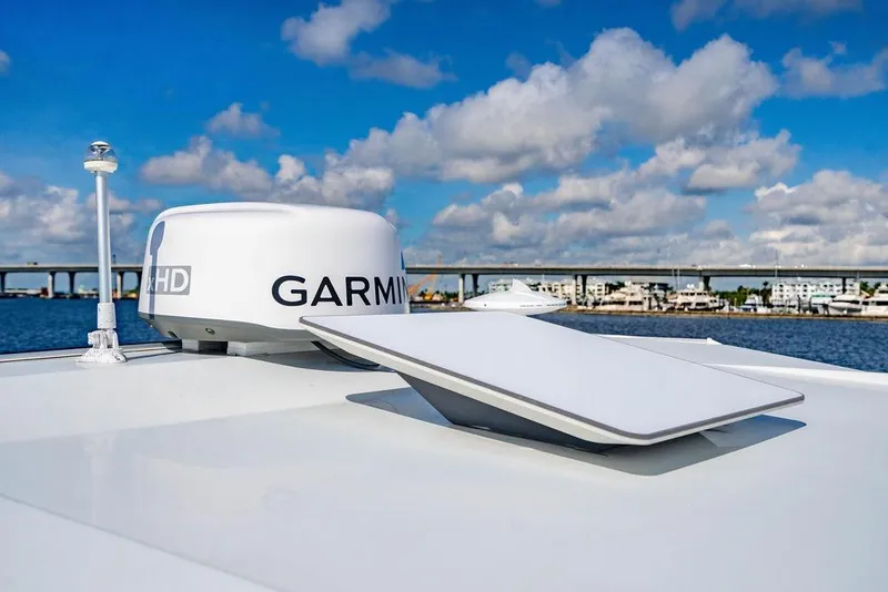 Slide: The Image of 2023 Jeanneau NC 1095 boat with Garmin radar, under a blue sky. - 35