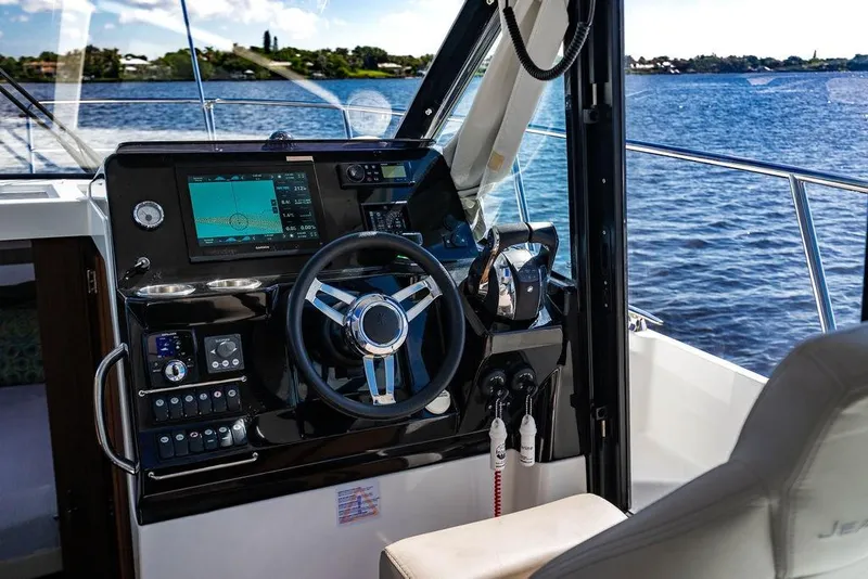 Slide: The Image of 2023 Jeanneau NC 1095 helm with modern navigation system on open water. - 48