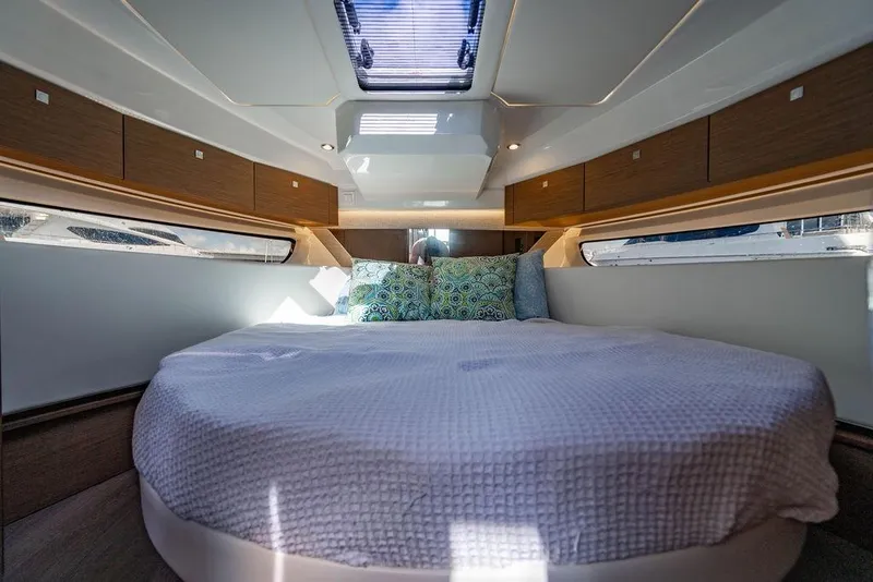 Slide: The Image of Luxurious cabin interior of 2023 Jeanneau NC 1095 with skylight and cozy bedding. - 55