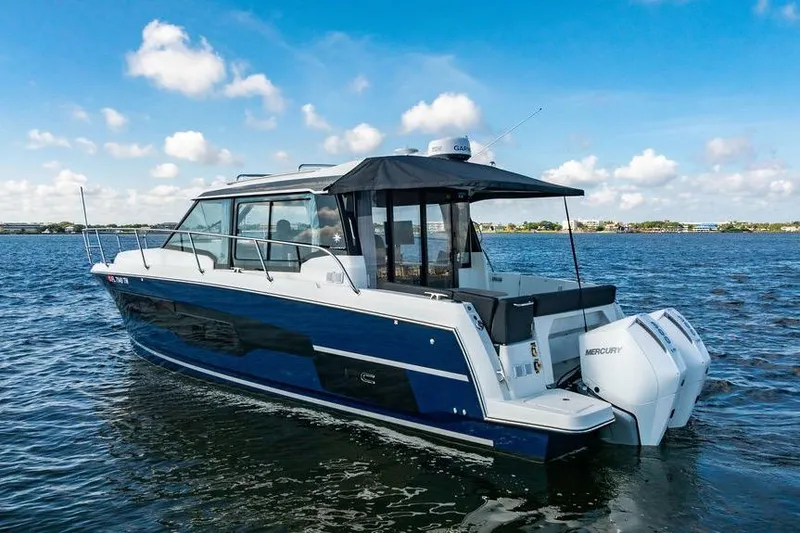 Slide: The Image of 2023 Jeanneau NC 1095 boat cruising on a sunny day with clear blue skies. - 6