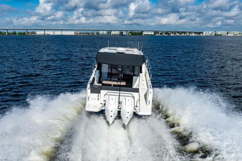 Slide: The Image of 2023 Jeanneau NC 1095 cruising on open water with twin engines. - 7