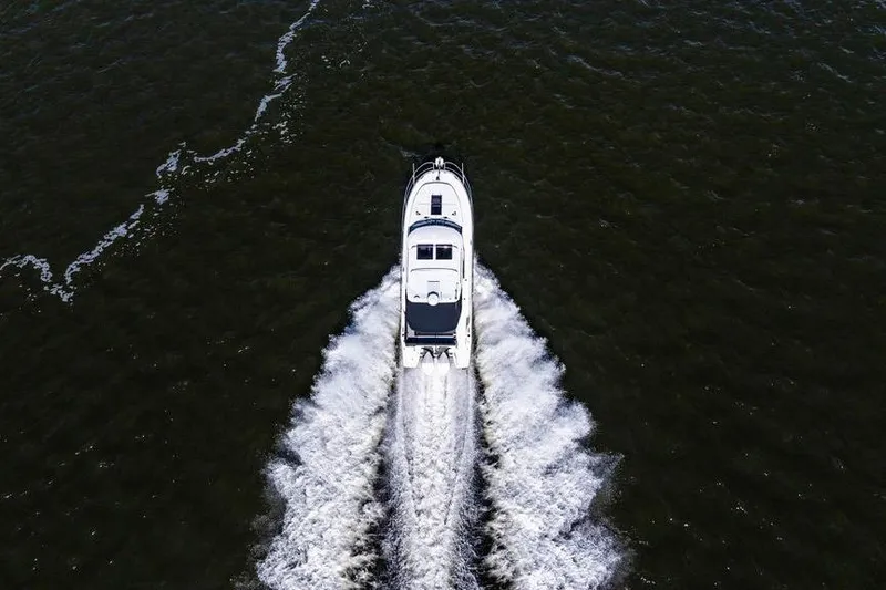 Slide: The Image of Aerial view of 2023 Jeanneau NC 1095 motorboat cruising on open water. - 9