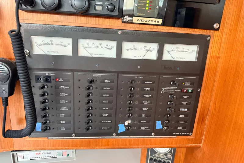 Slide: The Image of Electrical control panel on a 1987 Norseman 400 boat, featuring gauges and switches. - 69