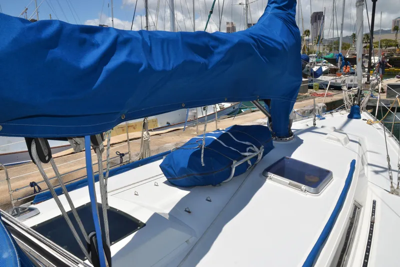 Slide: The Image of 1987 Norseman 400 sailboat deck with blue sail cover in marina. - 11