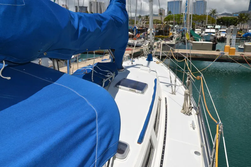 Slide: The Image of Sailboat Norseman 400, 1987 model, docked in marina with blue covers. - 13