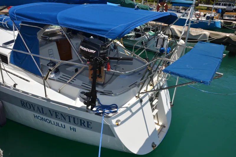 Slide: The Image of 1987 Norseman 400 sailboat "Royal Venture" docked in Honolulu, featuring blue canopy. - 14