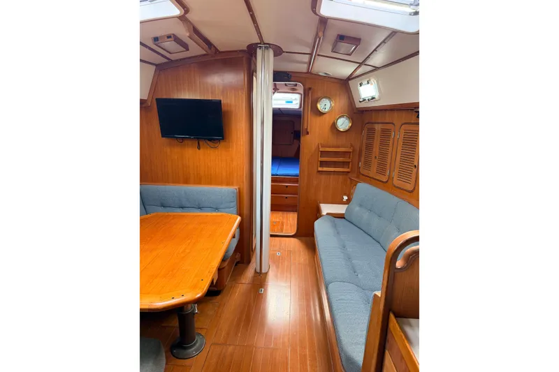 Slide: The Image of Interior of 1987 Norseman 400 sailboat with wooden furnishings and cozy seating area. - 43